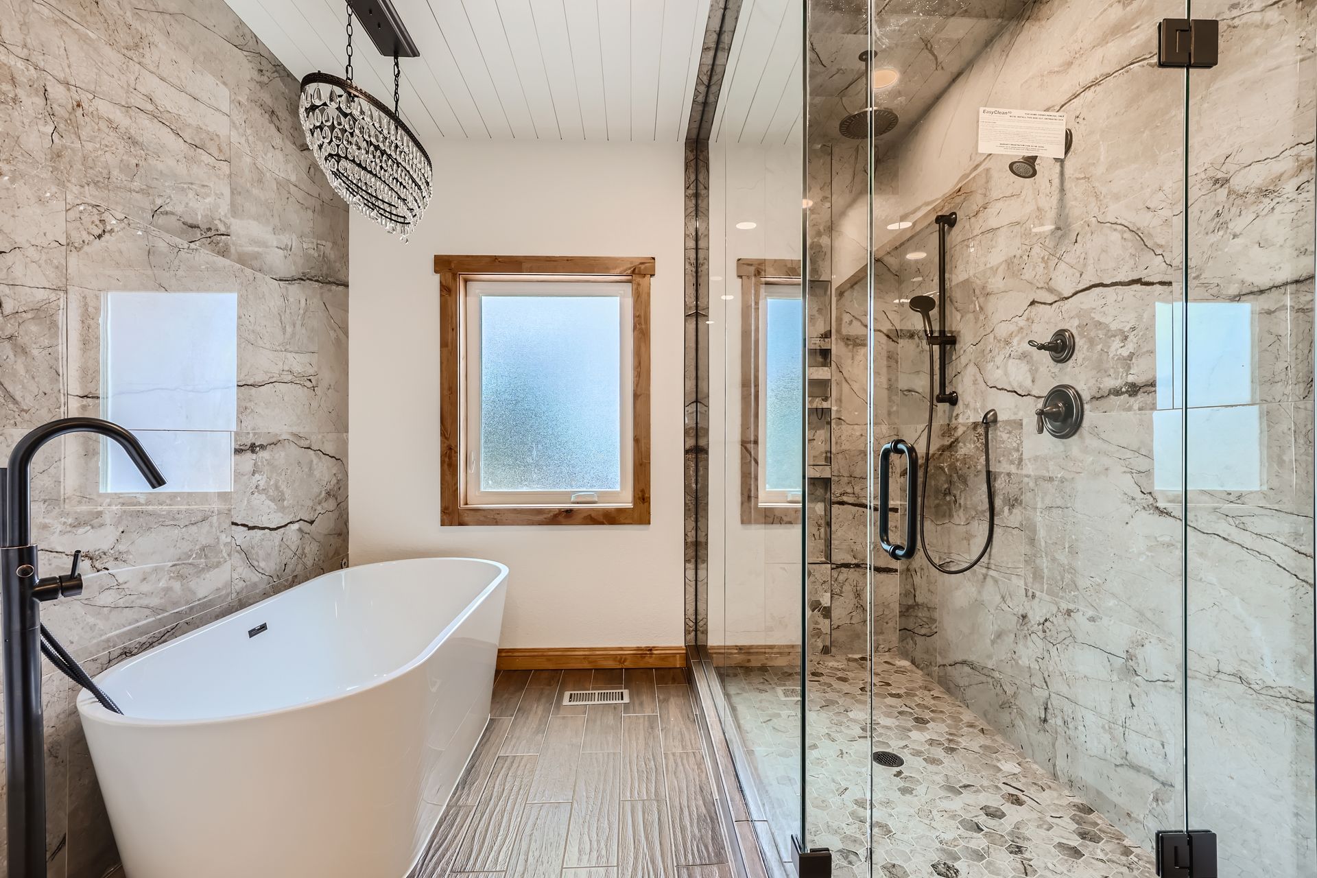 A bathroom with a bathtub and a walk in shower.