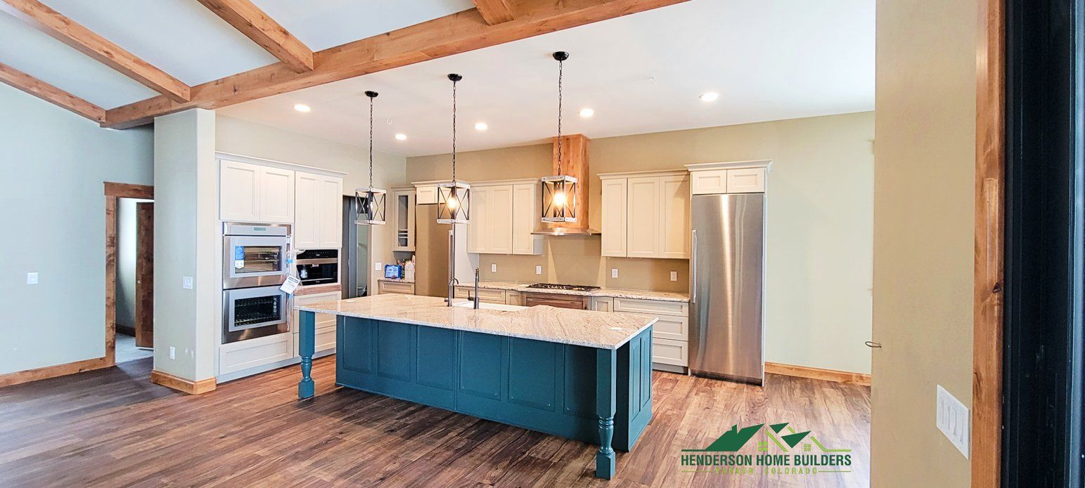 A kitchen with a large island in the middle of it and stainless steel appliances.