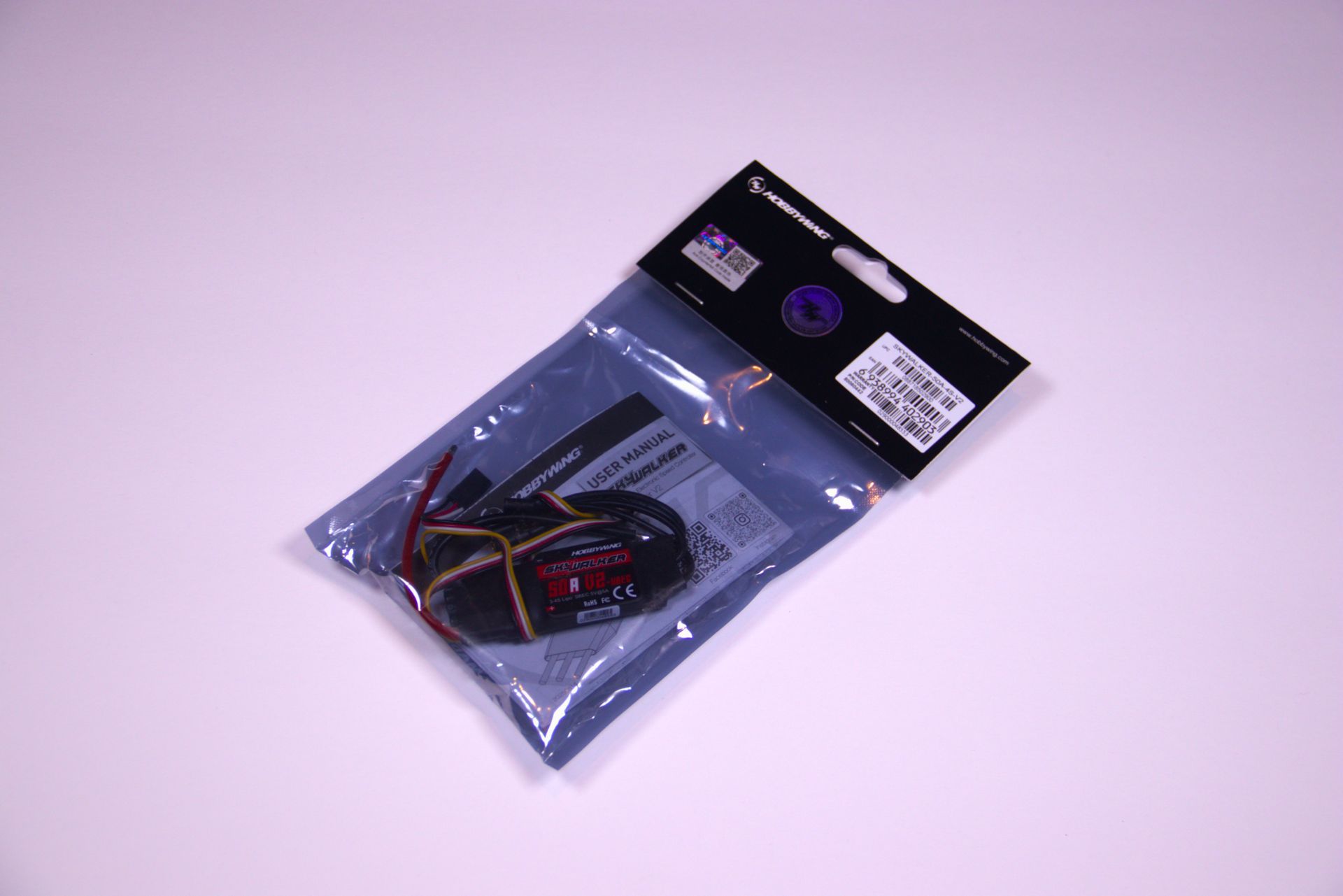 A packaged Spektrum brand electronic component, likely a drone receiver, in a sealed, anti-static plastic bag.