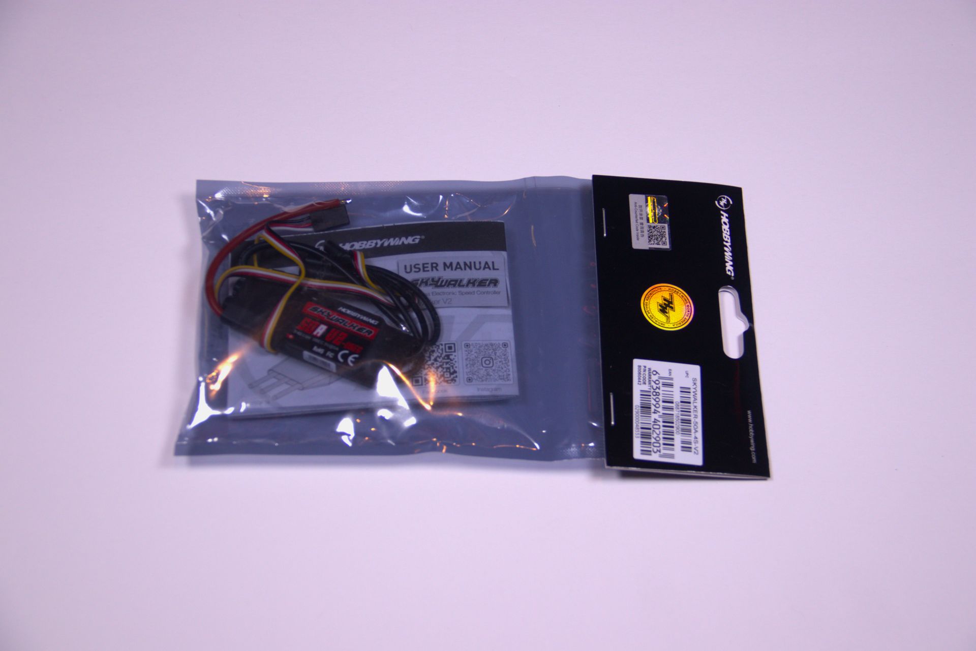 A packaged Spektrum brand electronic component, likely a drone receiver, in a sealed, anti-static plastic bag.