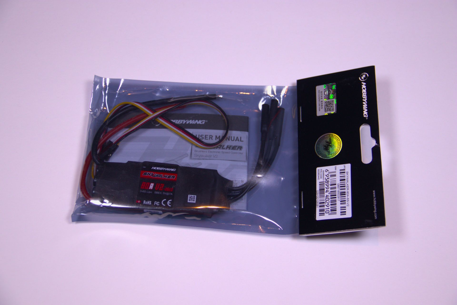 An electronic speed controller in its original plastic retail packaging against a plain white background.