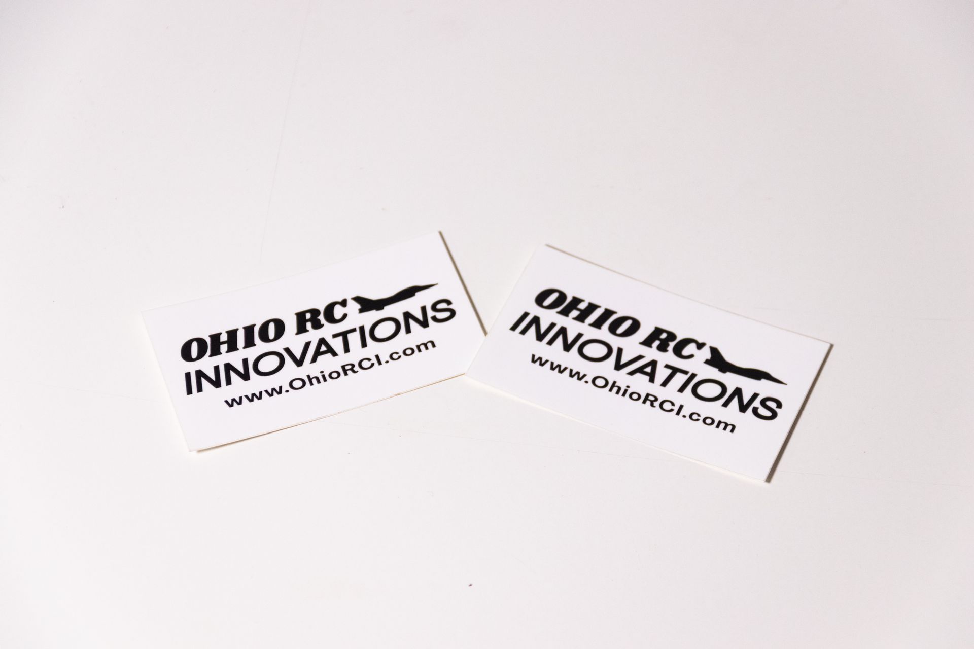 Two ohio rc innovations stickers are sitting on a white surface.