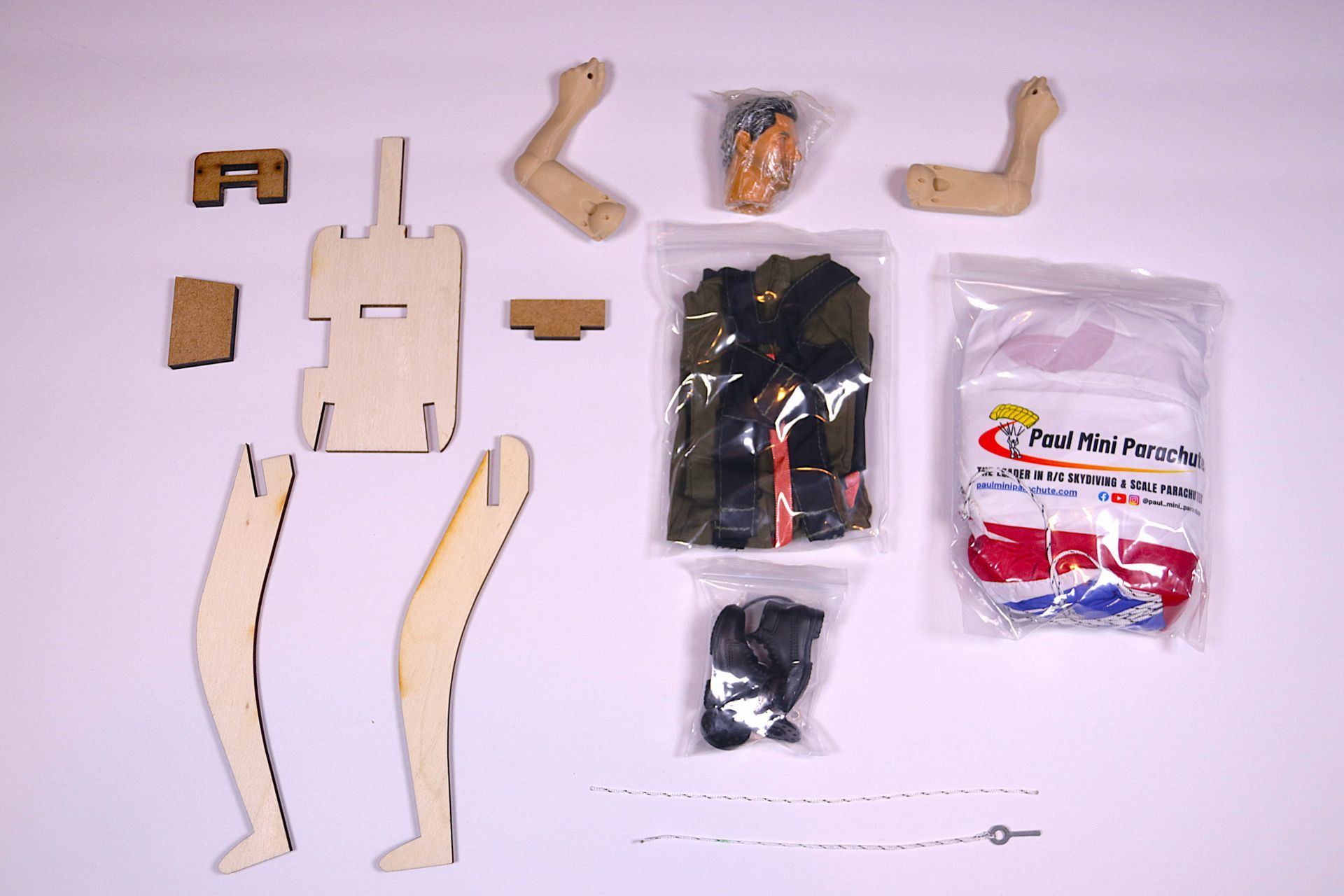 Open cardboard box with packaged items, including a white bag and small parts inside.