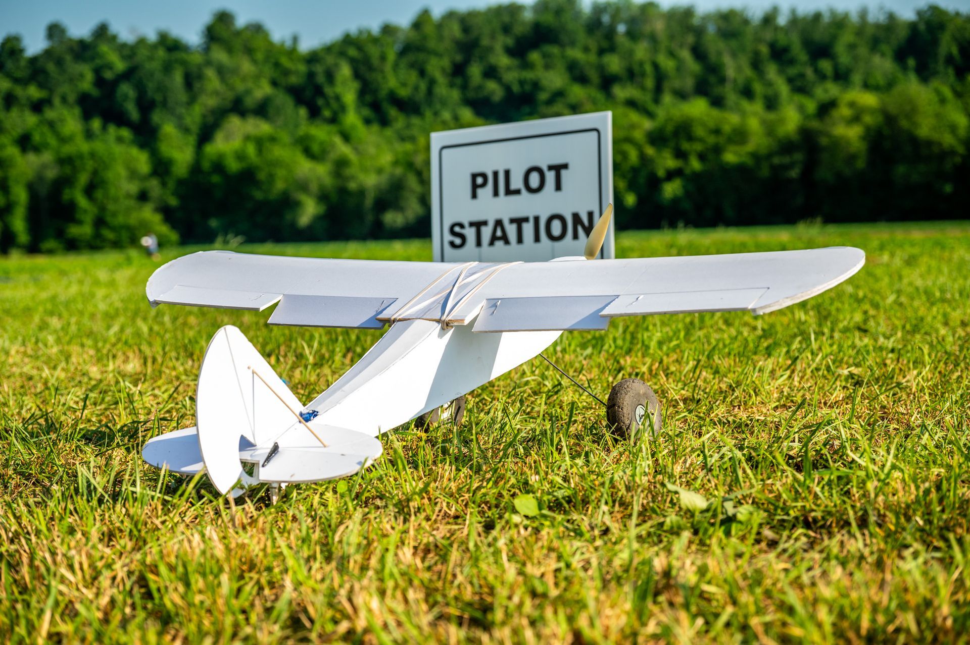 A small plane is flying through a clear blue sky.