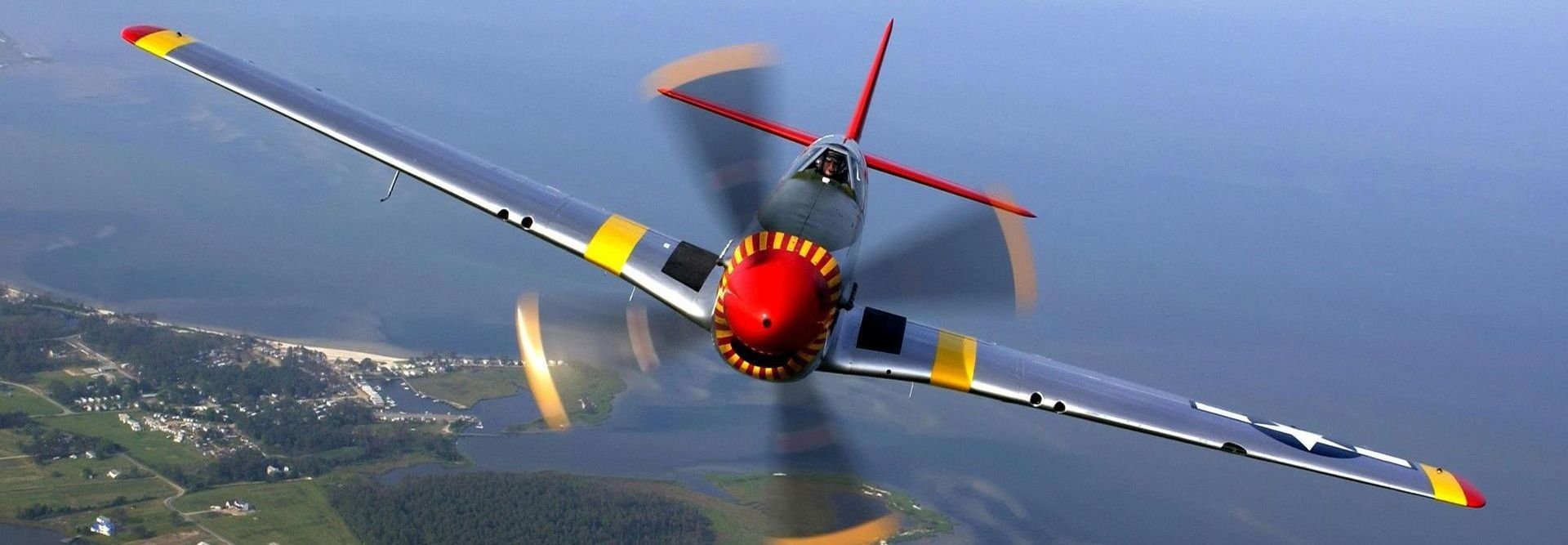 A red and yellow airplane is flying in the sky