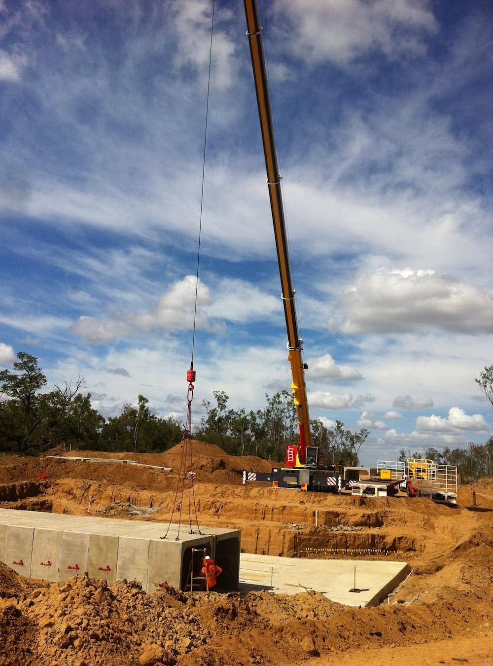 A Construction Site With A Crane Lifting A Concrete Block — SureLift Crane Hire In Moranbah, QLD
