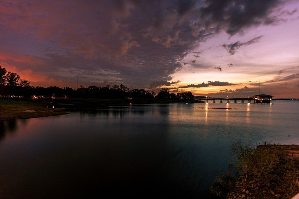 A Sunset Over A Body Of Water With A Bridge In The Background — Surelift Crane Hire In Nebo, QLD