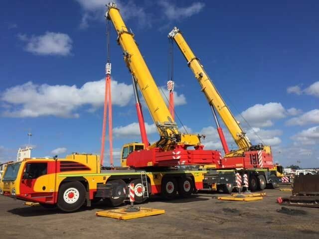 Two Crane Trucks Are Parked Next To Each Other In A Parking Lot — Surelift Crane Hire In Moranbah, QLD