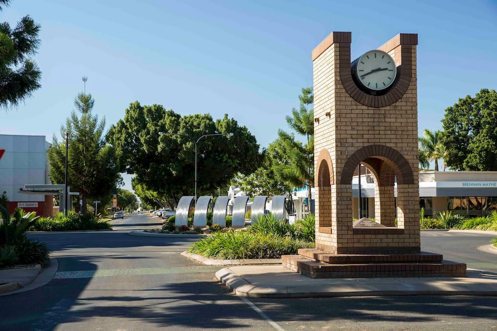A Brick Clock Tower In The Middle Of A Street  — SureLift Crane Hire In Emerald, QLD