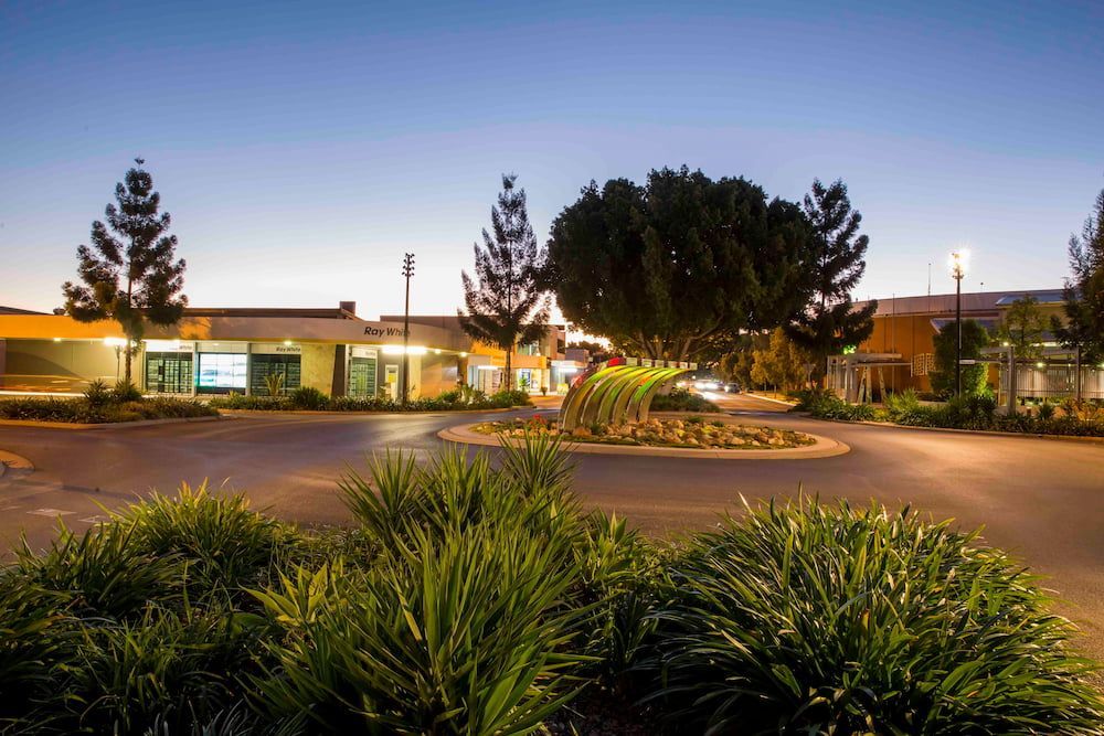 A Large Building With A Lot Of Trees In Front Of It  — SureLift Crane Hire In Emerald, QLD