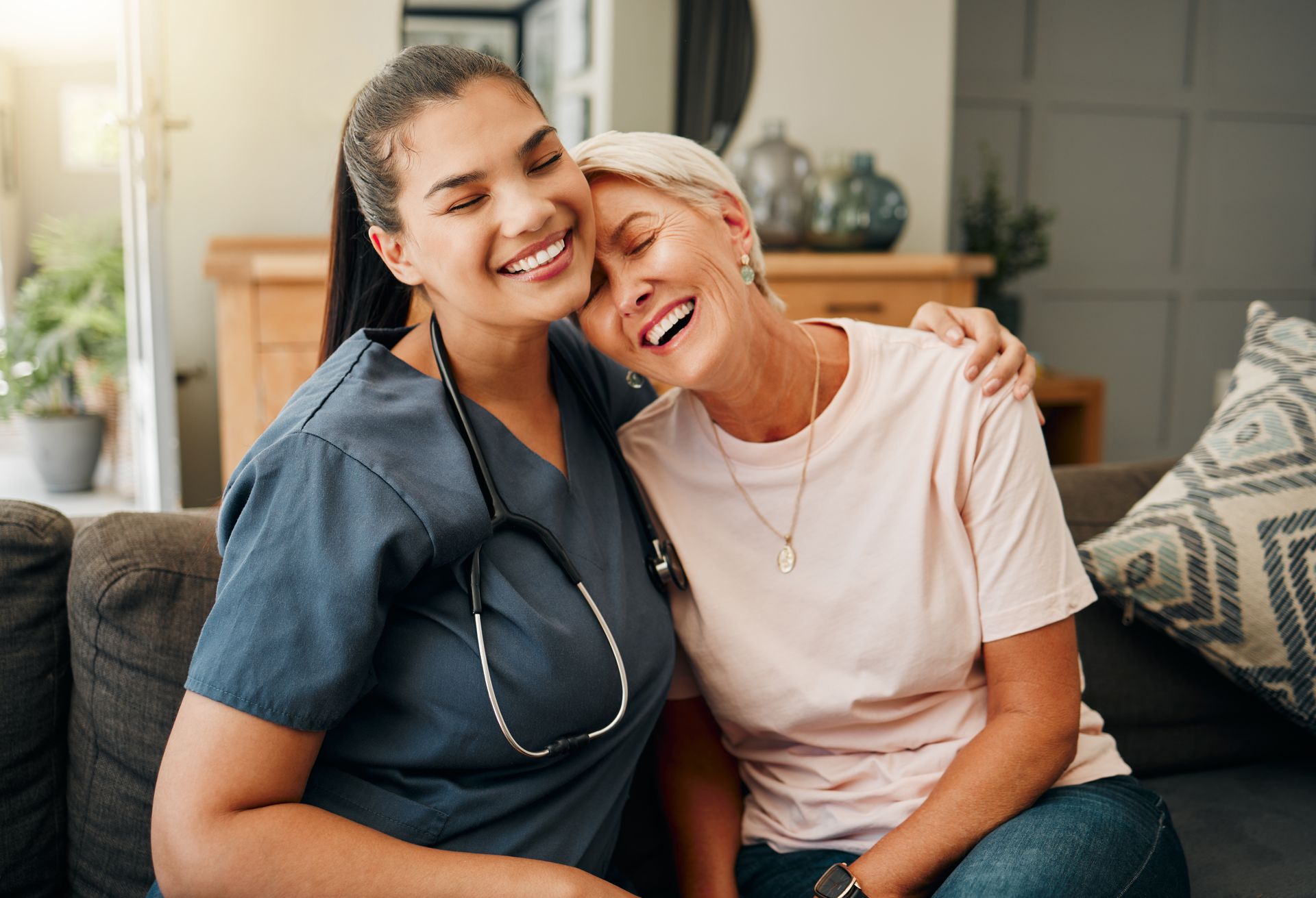Nurse assisting an elderly person using a walker outdoors