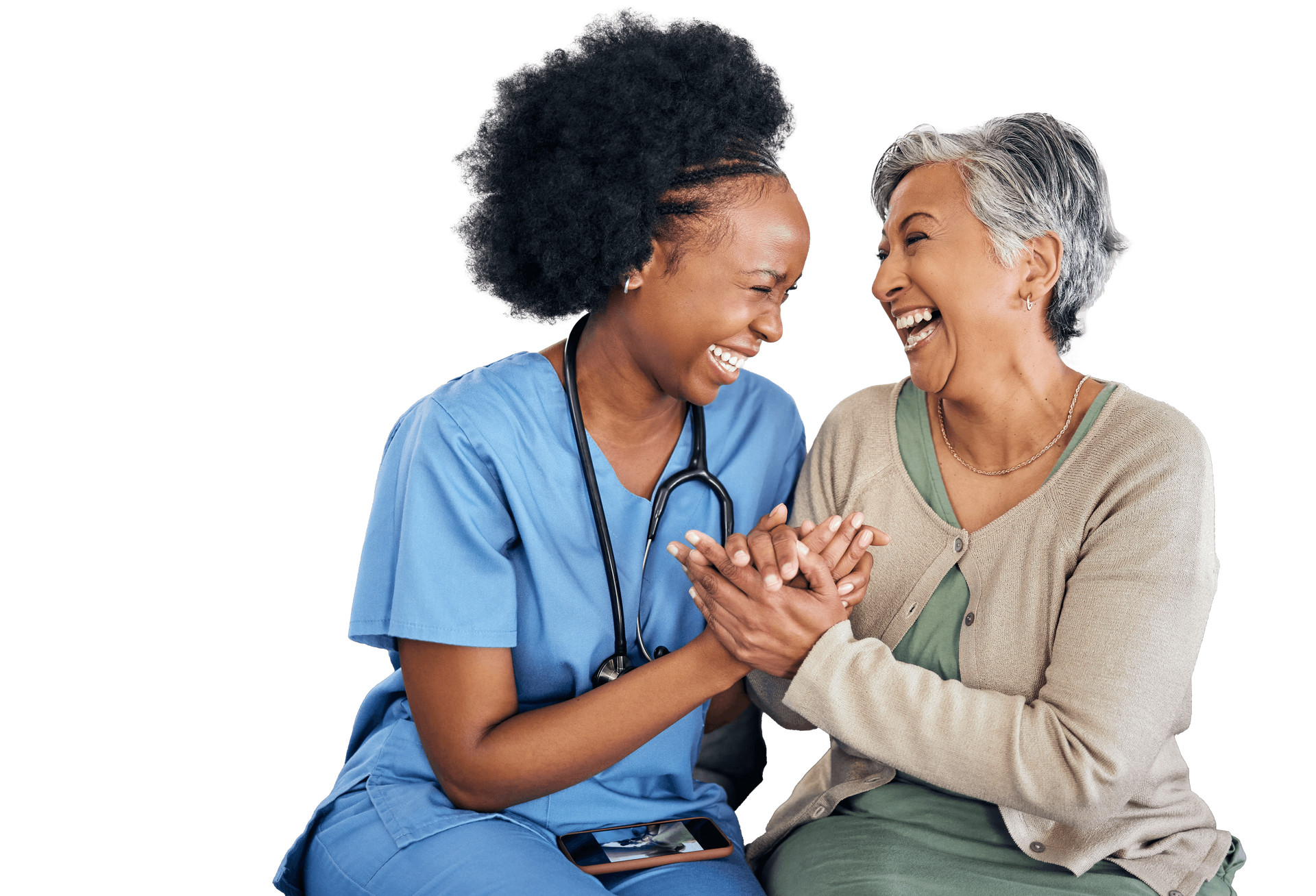 A healthcare worker in blue scrubs supports an elderly woman with a cane, both smiling
