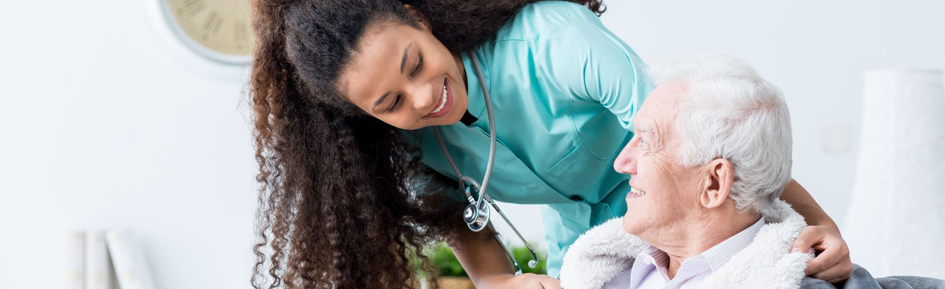 Woman embraces smiling older woman indoors