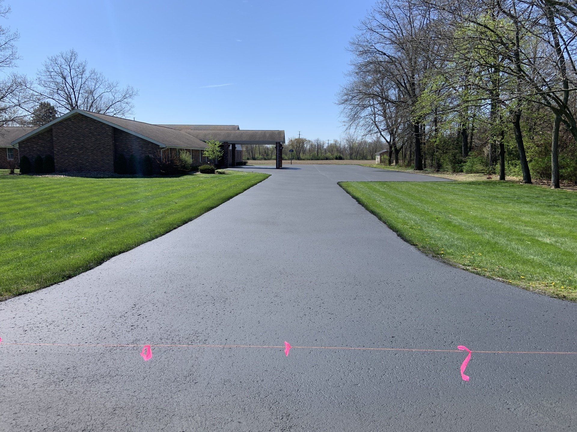 Spray sealcoat application of driveway and church parking lot in Milford, IN