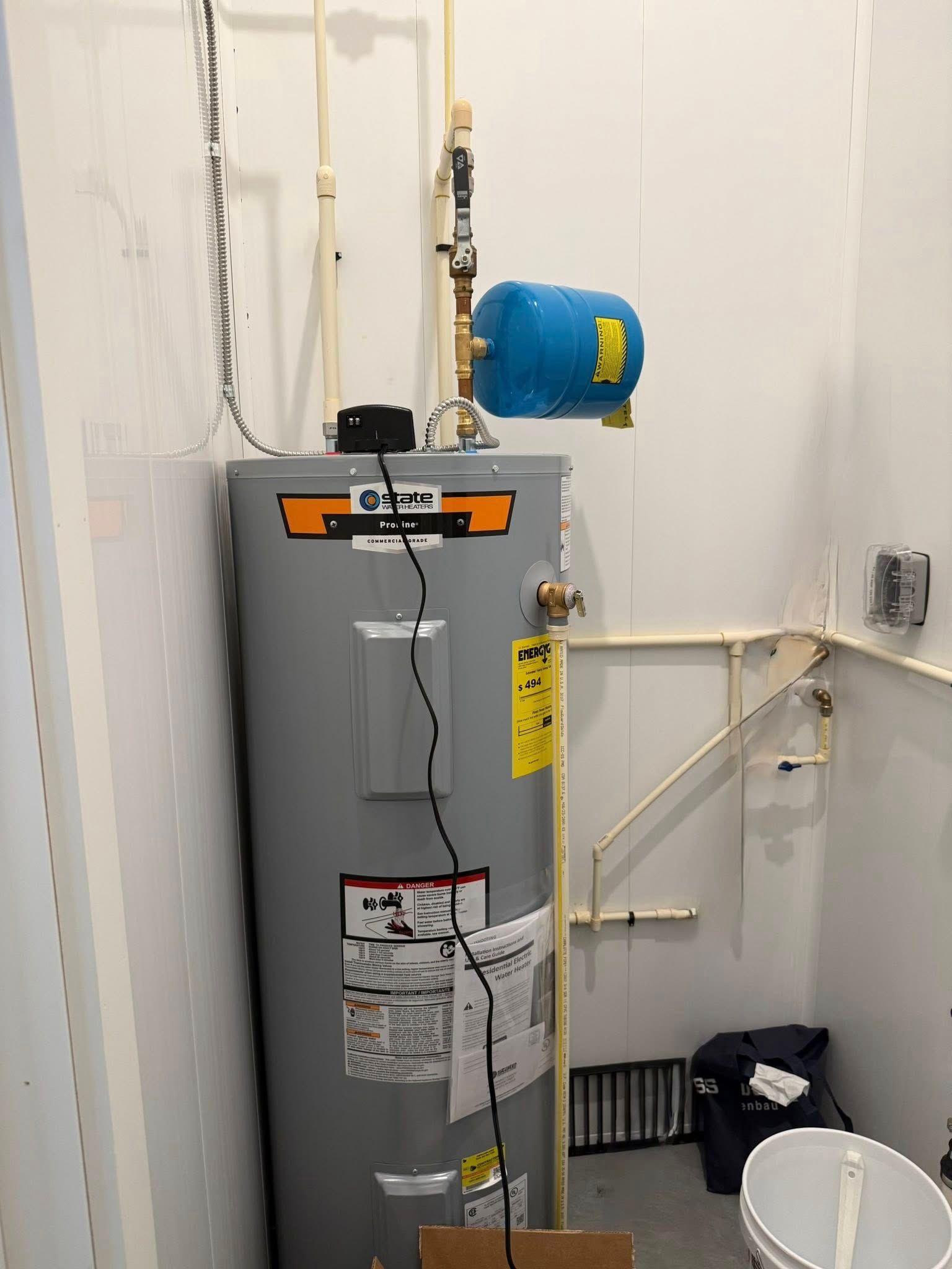 Interior view of a food processing facility with equipment; white walls and ceiling; overhead garage door track.
