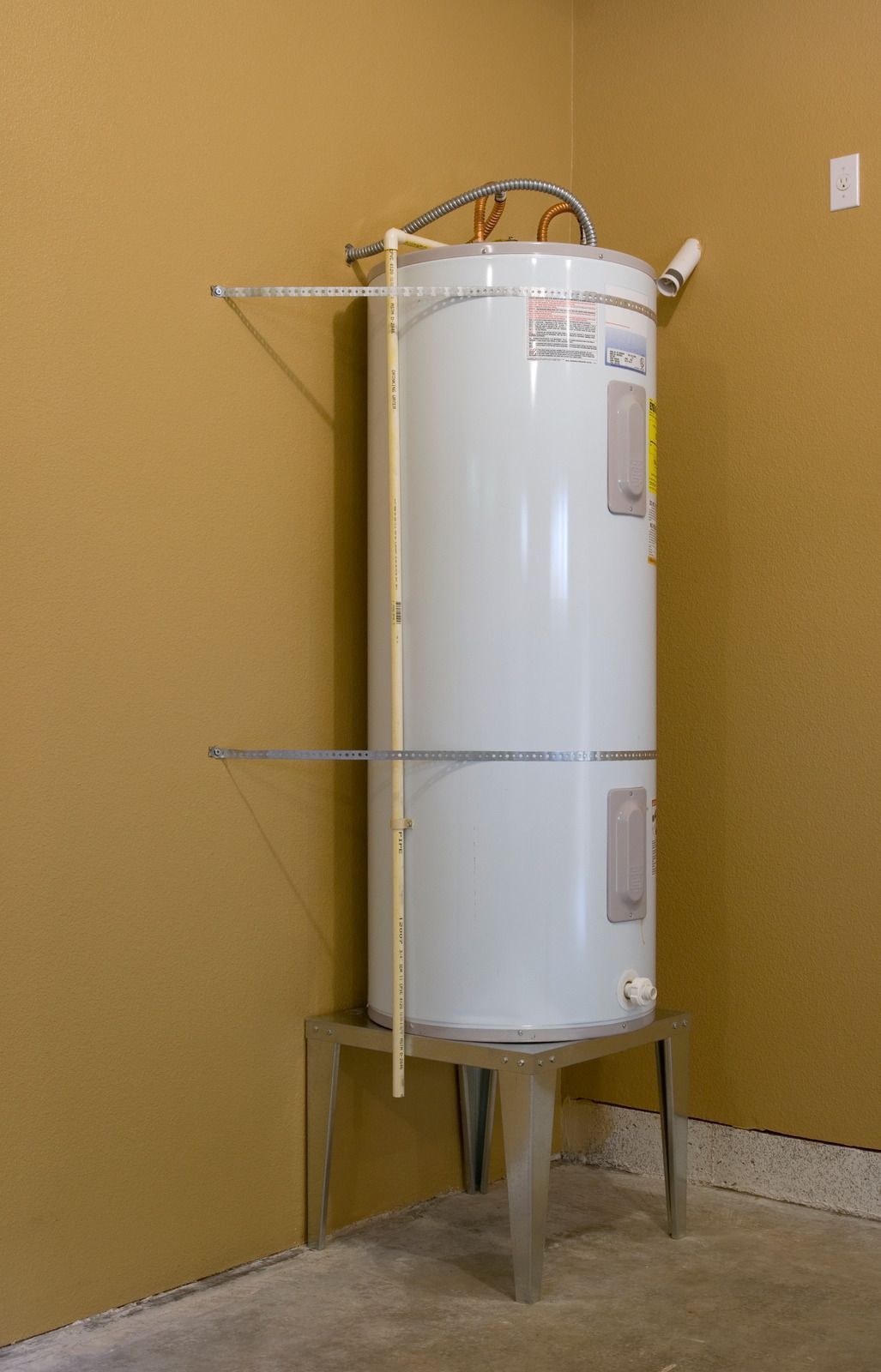 Water swirling down a shiny, metallic sink drain.