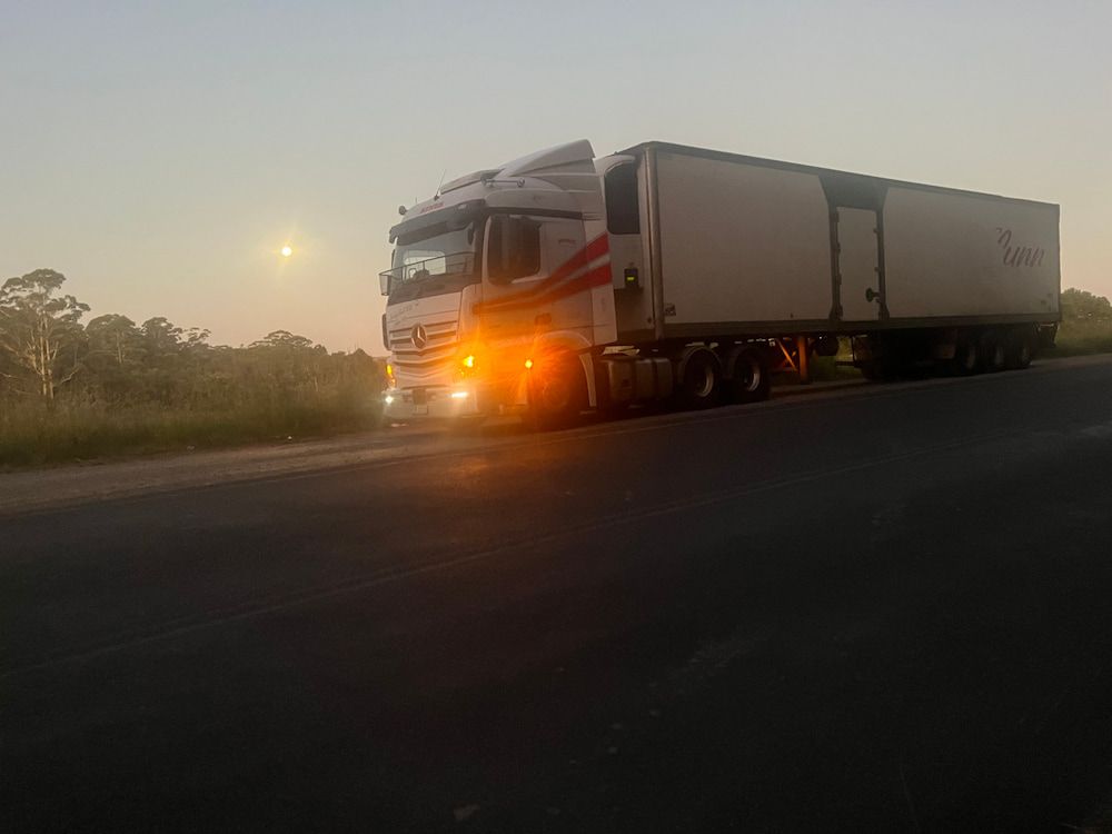 A Semi-truck With Trailer Parked on the Side of a Road — Hines Refrigerated Transport Pty Ltd in Kundabung, NSW