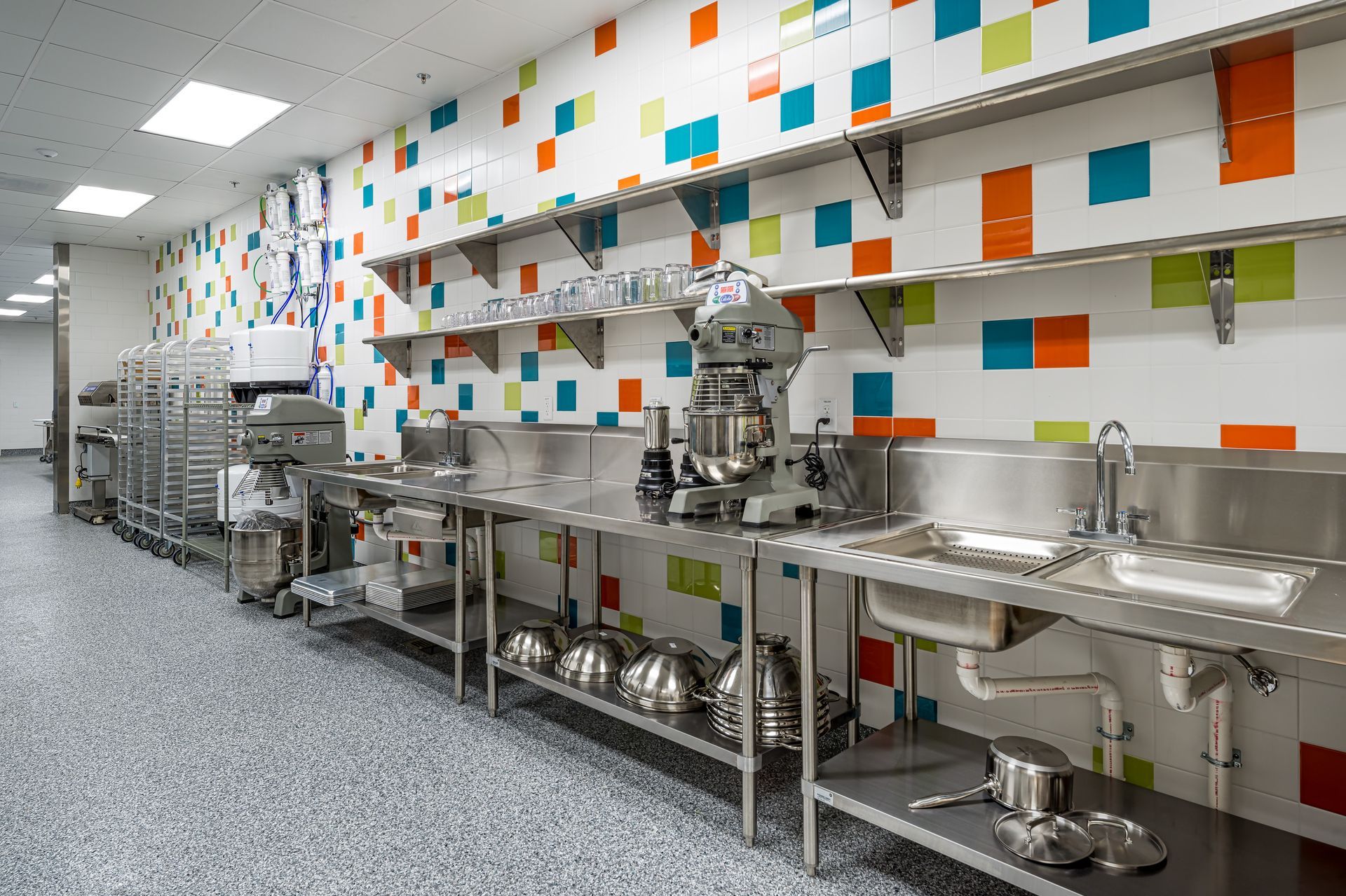 A row of white trucks are parked in front of a building.