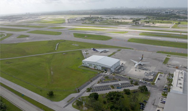 An aerial view of an airport with planes parked on the runways