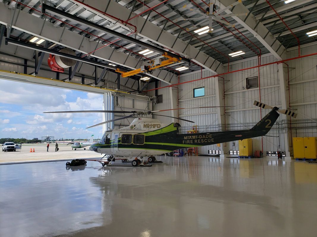 An aerial view of an airport with planes on the runways.