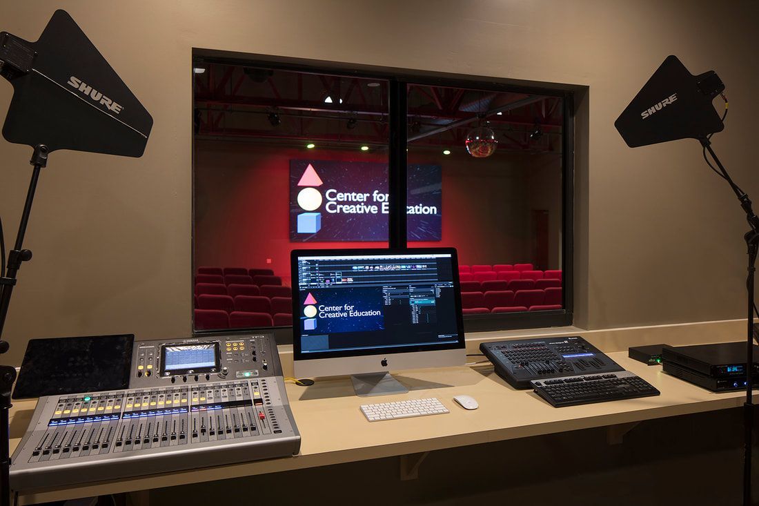 A computer monitor is on a desk in front of a window with a screen that says center for connecticut