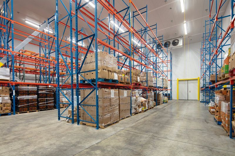 A large warehouse filled with lots of boxes and shelves.