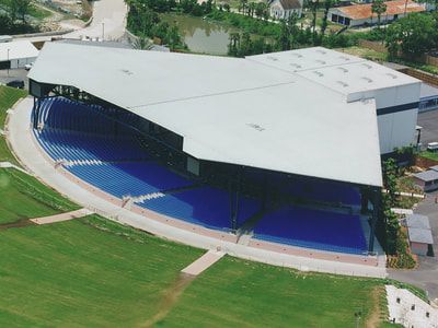 An aerial view of a large building with a curved roof