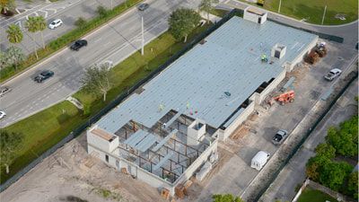 An aerial view of a building under construction next to a road.