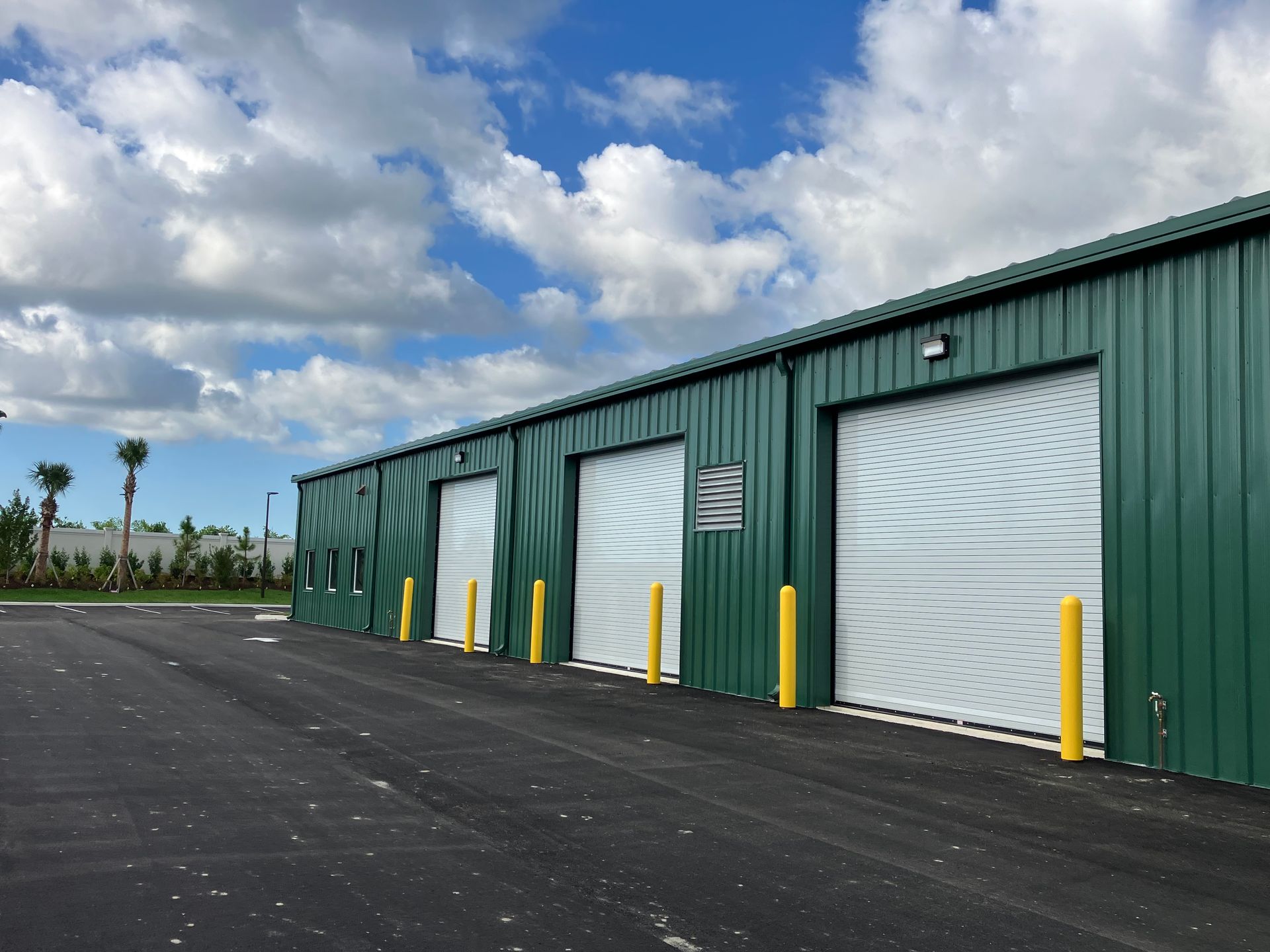 A large metal structure is being built on a sunny day.