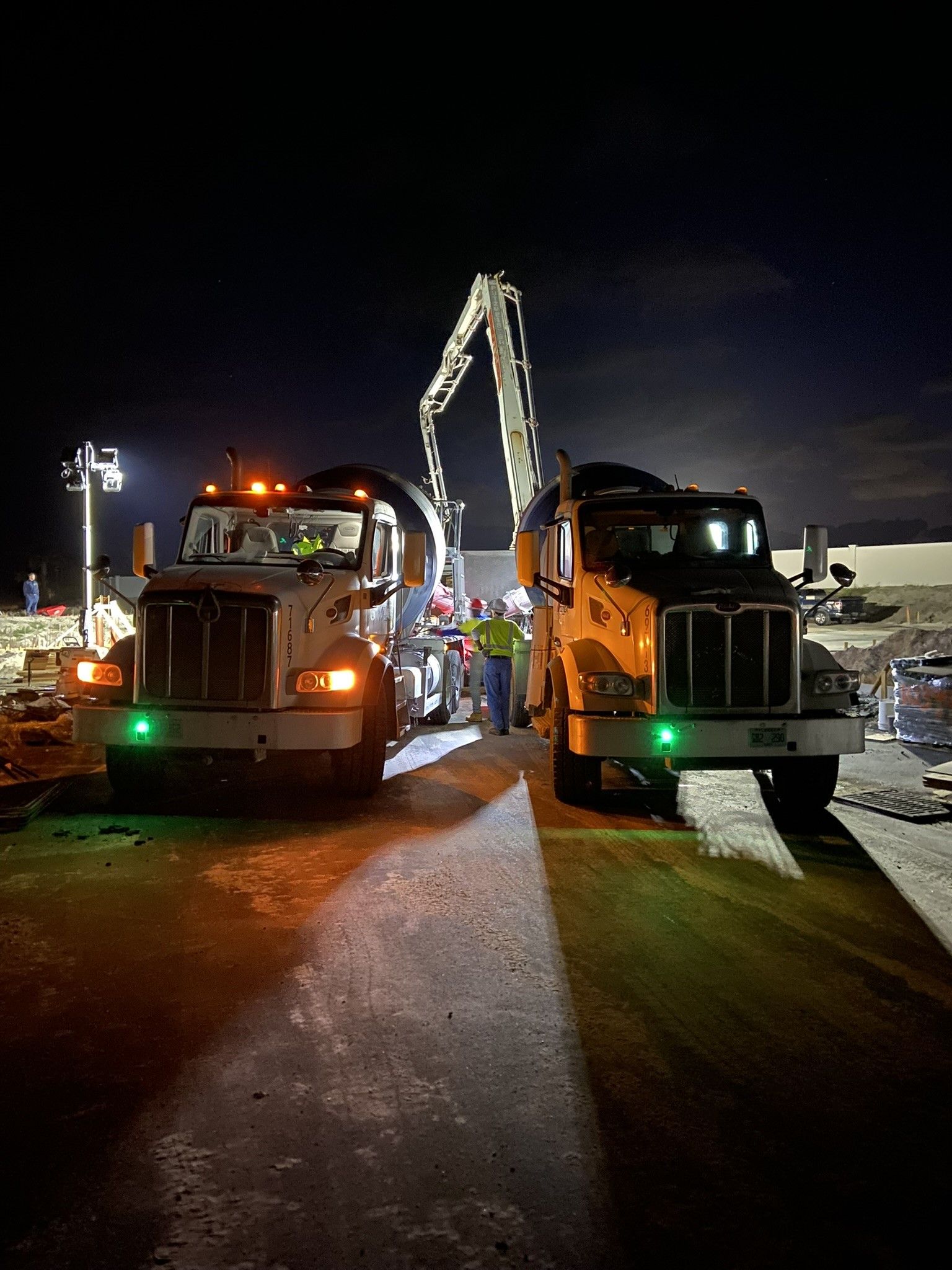 A man is working on the roof of a brick house