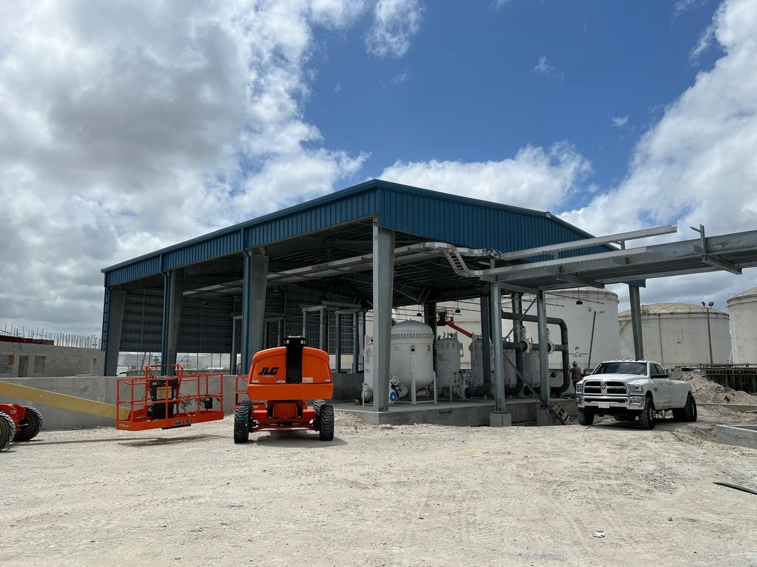 A truck is parked in front of a building under construction.