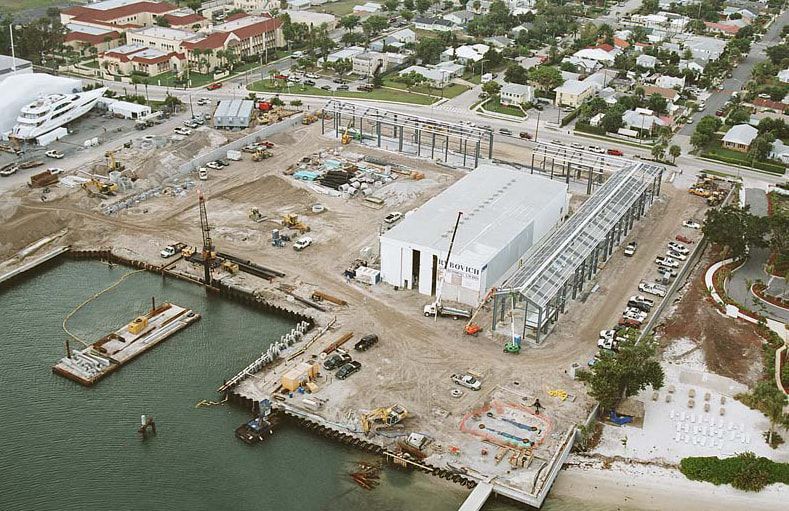 An aerial view of a construction site next to a body of water.