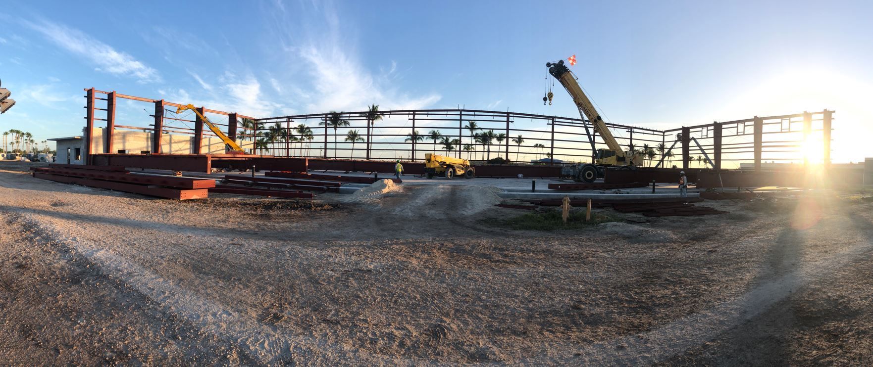 A large building under construction with a crane in the foreground.