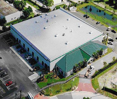 An aerial view of a large building with a green roof