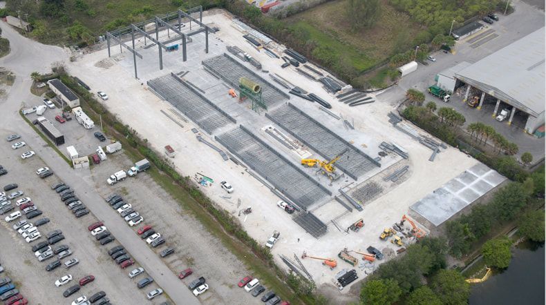 An aerial view of a parking lot with cars parked in it