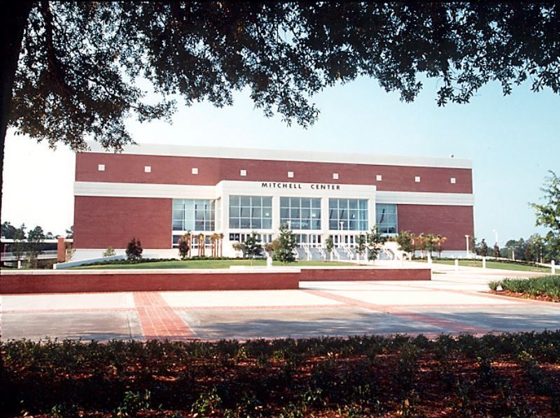 A large brick building with the word mitchell center on it