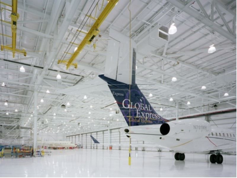 A plane in a hangar that says global express on the tail