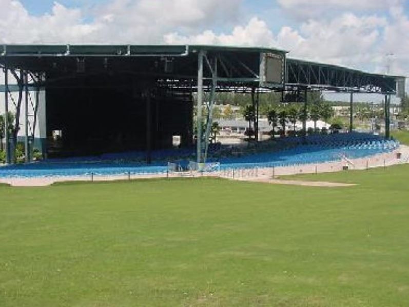 There is a large stage in the middle of a field.