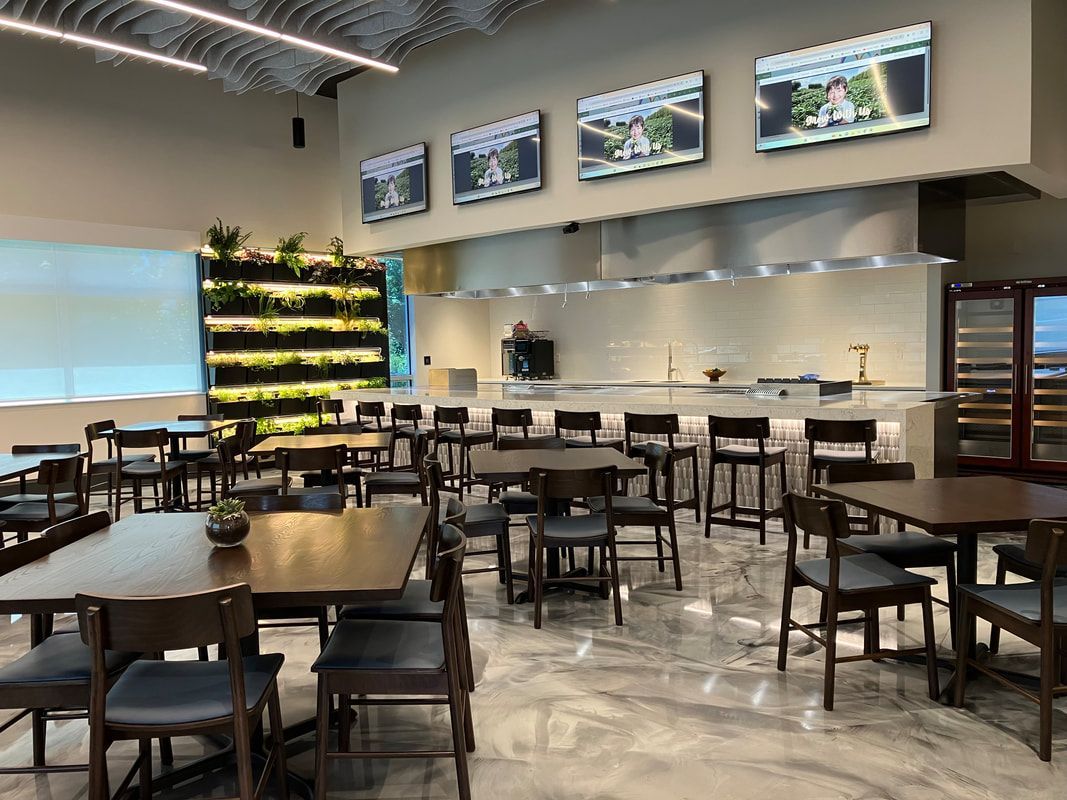 A large dining room with tables and chairs in a restaurant.