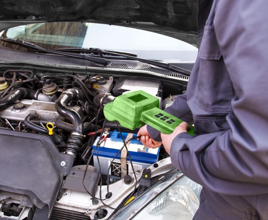 A Man Is Working On The Engine Of A Car — A.G Auto Electrical & Air-Conditioning In Hidden Valley, QLD