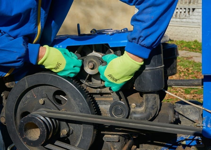 A Person Wearing Yellow Gloves Is Working On A Machine — A.G Auto Electrical & Air-Conditioning In Hidden Valley, QLD