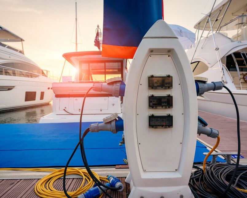 A Boat Is Being Charged At A Charging Station On A Dock — A.G Auto Electrical & Air-Conditioning In Hidden Valley, QLD