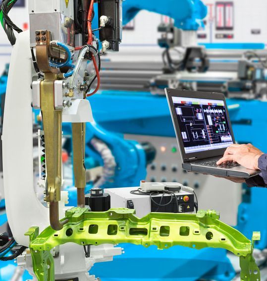 A Person Is Using A Laptop Computer In Front Of A Robotic Arm — A.G Auto Electrical & Air-Conditioning In Hidden Valley, QLD