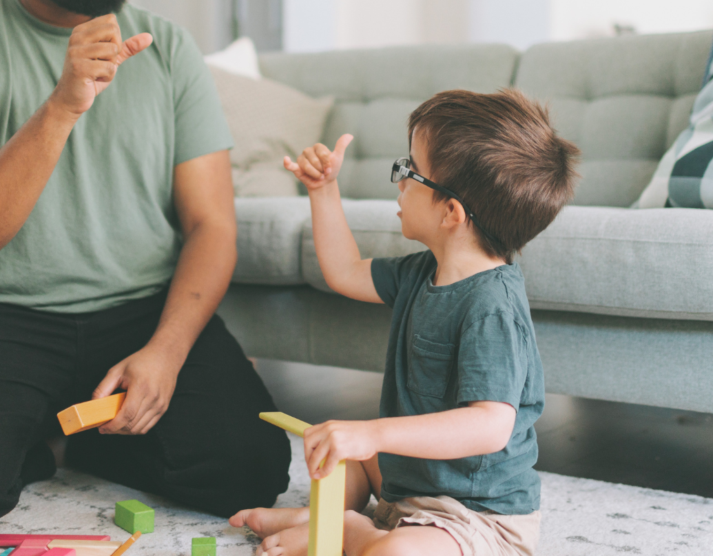 A woman is sitting next to a boy in a wheelchair.