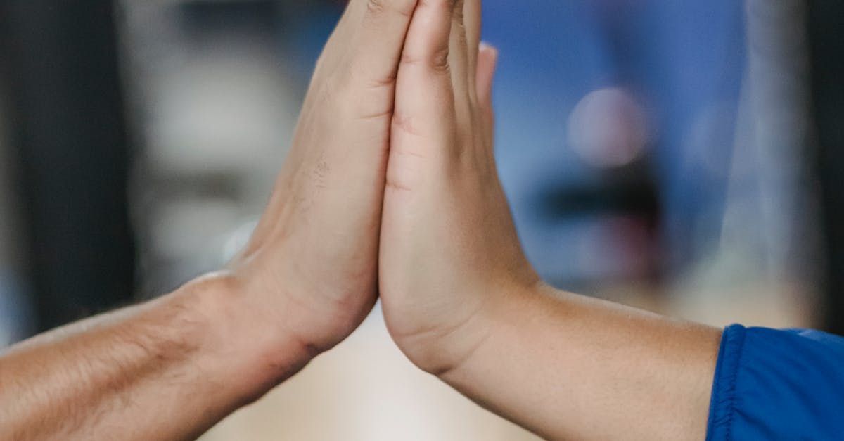 A man and a woman are sitting at a table talking to each other.