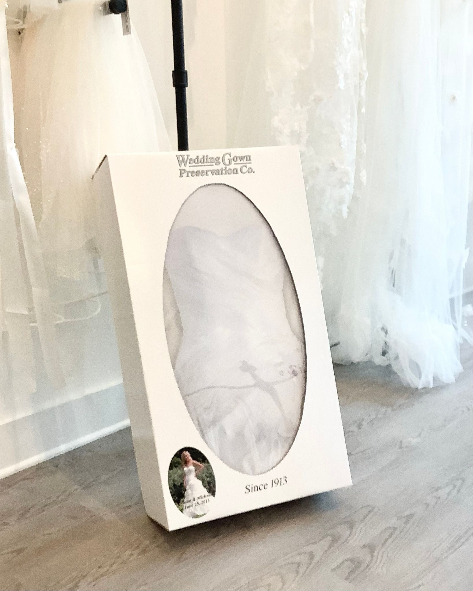 A bride in a wedding dress is standing on a set of stairs holding a bouquet of flowers.