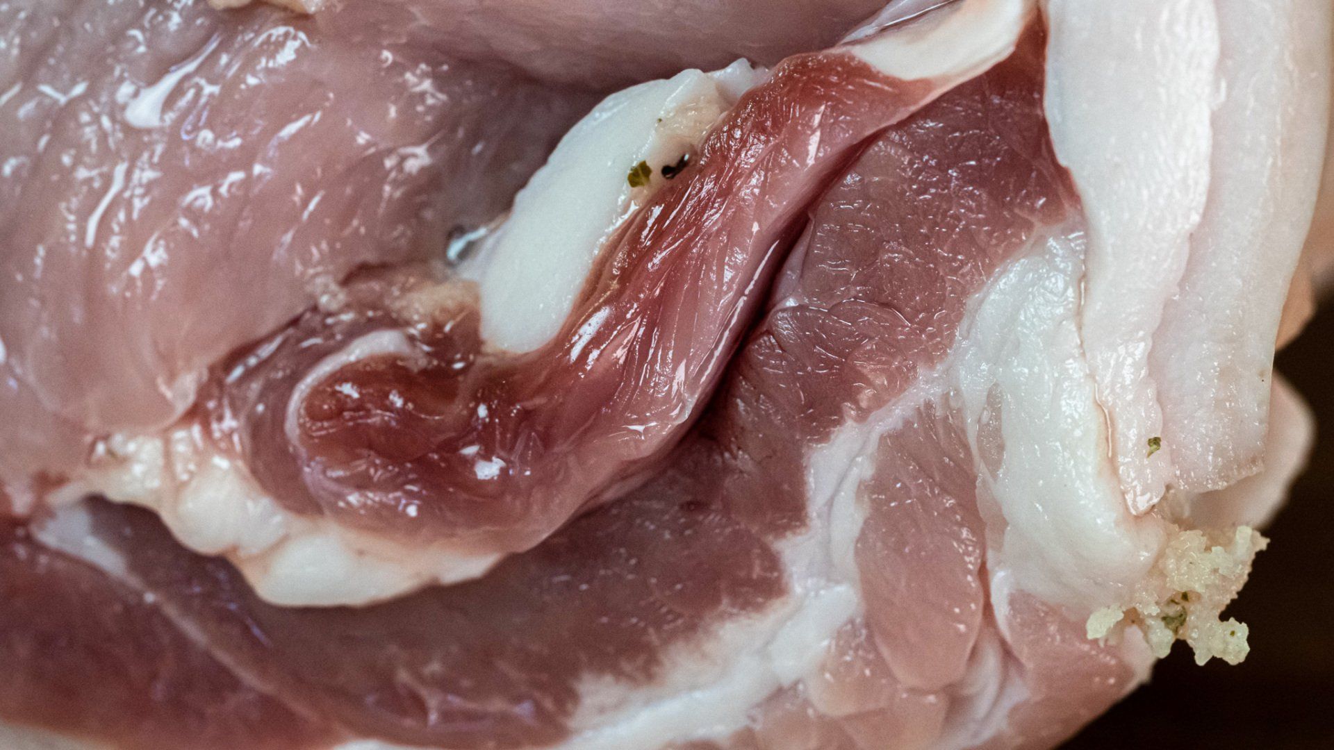 A close up of a piece of raw meat on a table.