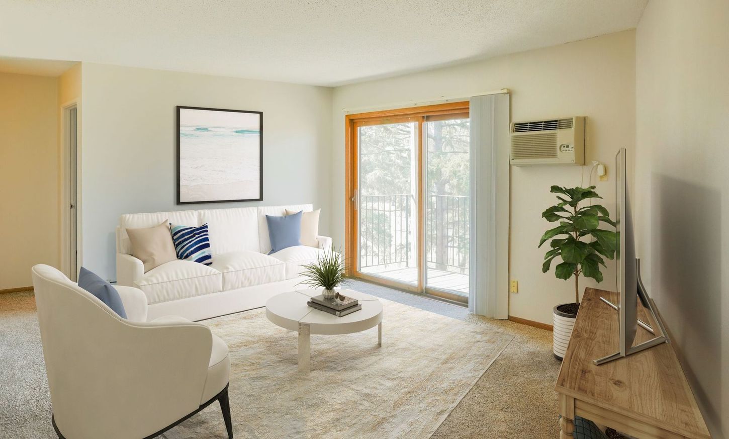 A living room with a couch , chair , coffee table and television.