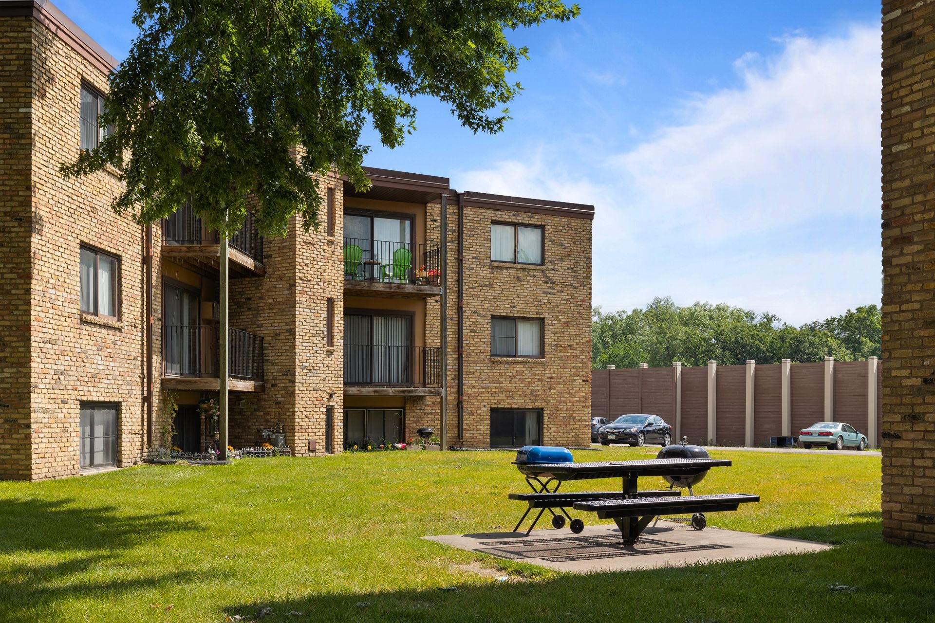 A brick building with a picnic table in front of it