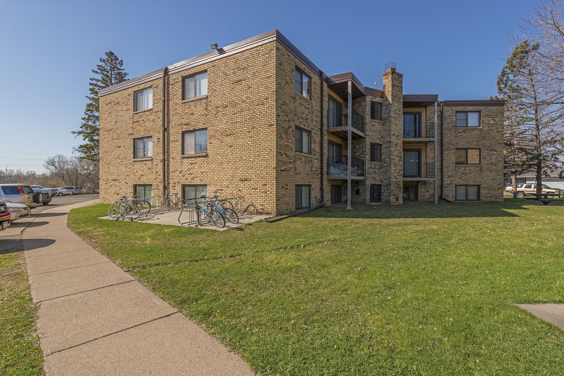 A large brick apartment building with bikes parked in front of it